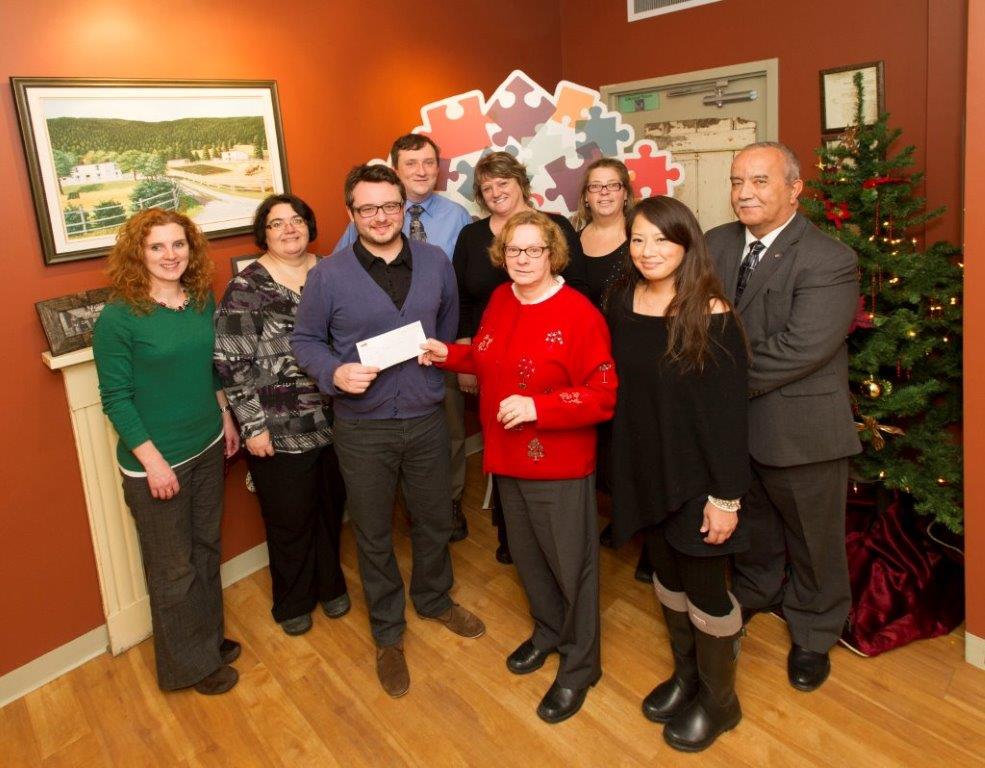 Members of MESC made a holiday donation to the Autism Society