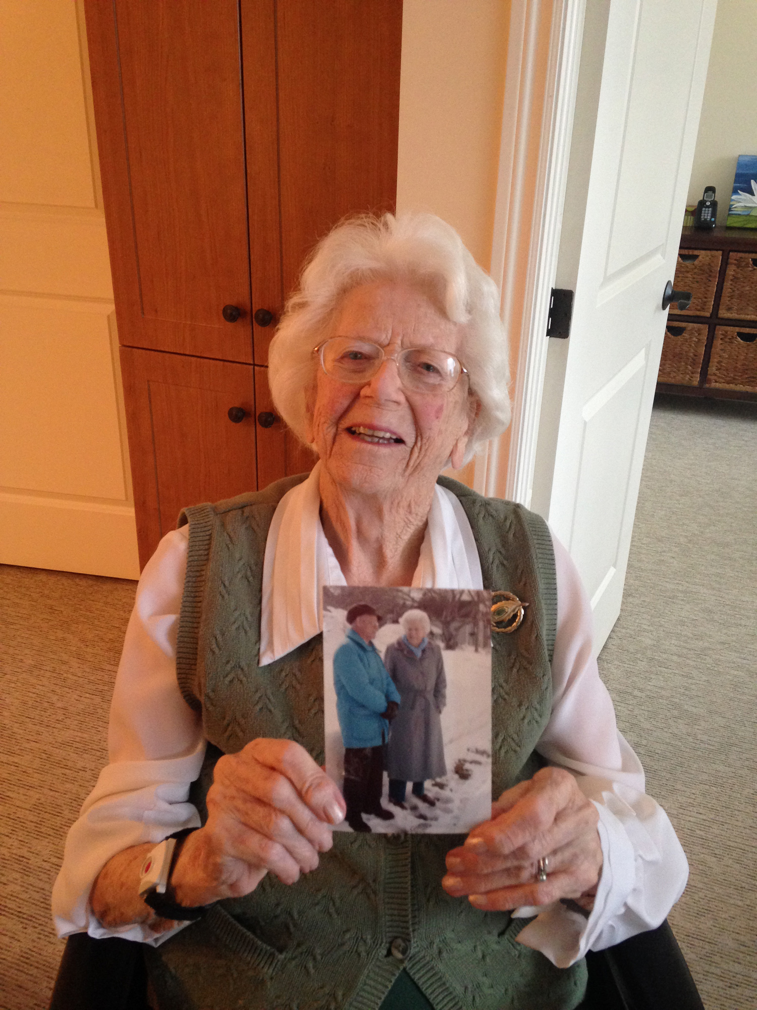 Helen Whiteway, a 102-year-old Memorial alumna, holds a photo of her and Dr. Hugh Anderson taken in St. John’s. The two were close personal friends. 