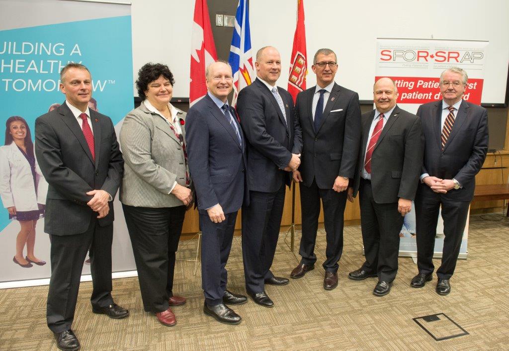 Speakers at the news conference to announce the TMPI include (from left): Senator David Wells, Dr. Jane Aubin, Dr. James Rourke, Ralph Chapman, IBM, Premier Paul Davis, Dr. Gary Kachanoski and Dr. Pat Parfrey.